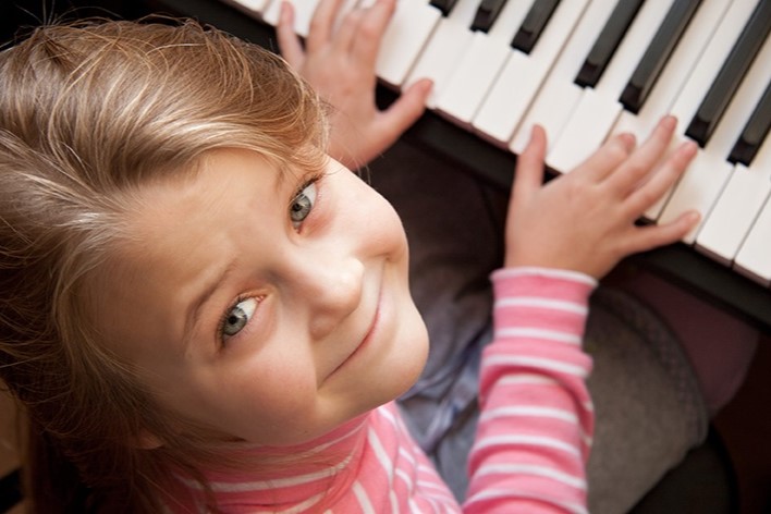 Girl taking piano lessons